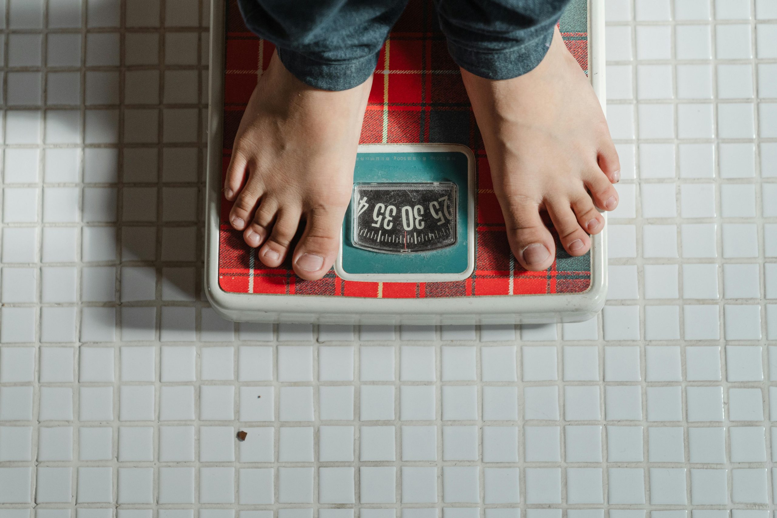 Person standing on a scale to measure weight loss